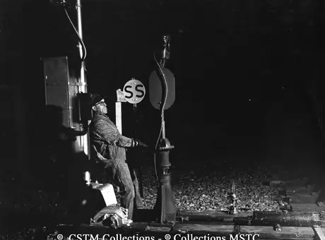 Brakeman J.A. Laferrière turning the switch to allow freight “495” to move in the siding to pick up cars destined for Toronto
