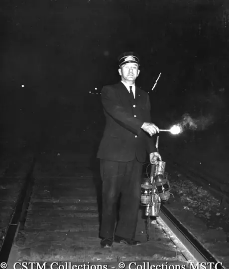 Rear end brakeman using oil lanterns for signaling