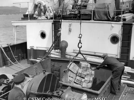 Freight from the cargo hold of the S.S. Bar Haven, docked at Woody Island