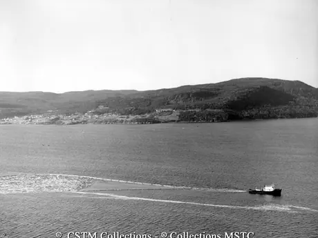 Tug boat transporting logs to the Bowater’s Newfoundland Pulp and Paper Mills Limited