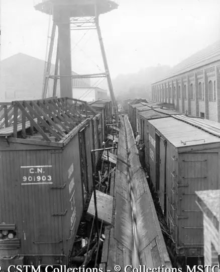 Unloading pulp logs from railway cars at the Laurentide Pulp Mill