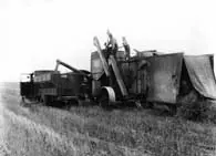 Holt Combined Harvester Model 36 loads a Federal grain truck