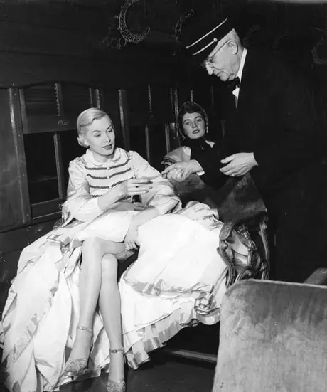 The conductor takes a passenger’s ticket for a journey on the Museum Train