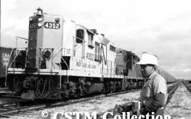 A CN employee uses a remote control device to operate a diesel locomotive on the Great Slave Lake Railway in 1968