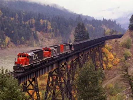 Three SD-40 diesel locomotives on Anderson Creek bridge with a coal train