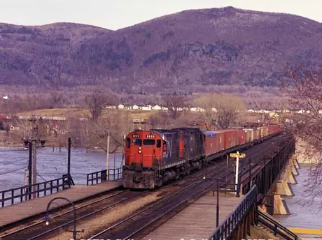 Diesel locomotives M-424 3205 and 3211 with a container train on Beloeil Bridge