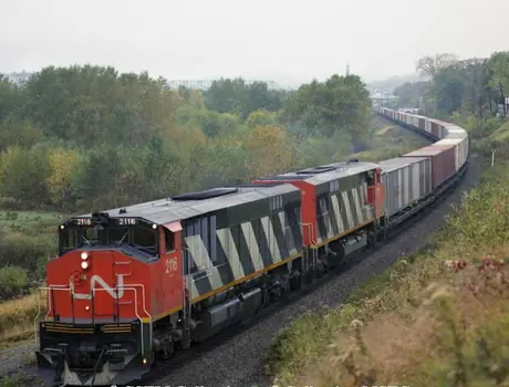 Diesel locomotives HP-616 2116 and 2115 built by Montreal Locomotive Works with a container train.  The class was the first built with a Draper Taper.