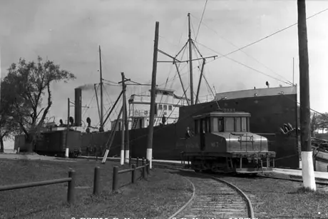 The Niagara, St. Catharines & Toronto Railway electric locomotive no. 7 traveling alongside the Welland Canal