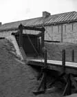 Wooden trestle bridge and doors at the entrance to Fort Erie