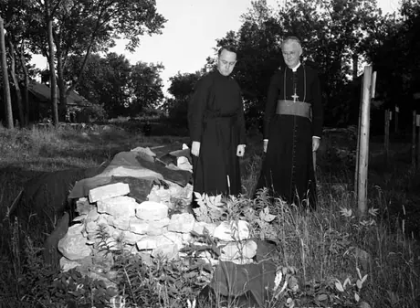Rev. J.L. Swain and Archbishop Beckman examining foundation stones of one of the four bastions recently excavated by the Royal Ontario Museum of Archaeology