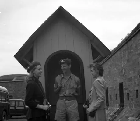 Tourists speaking with a guard at his command post, Citadel, Quebec