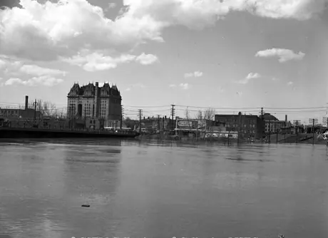 A view of the Red River, with the back of the Canadian National Station in the foreground and the Fort Garry Hotel on the left