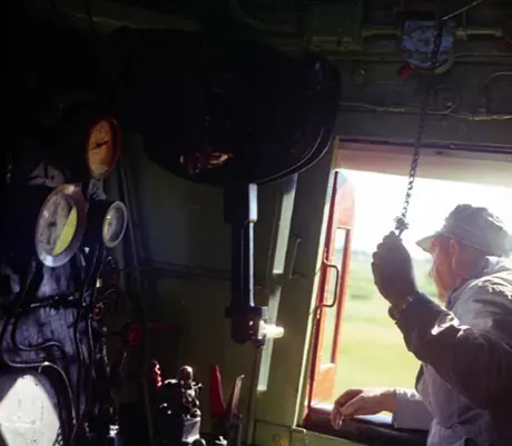 Engineer blowing the whistle of locomotive no. 6218 on its last run