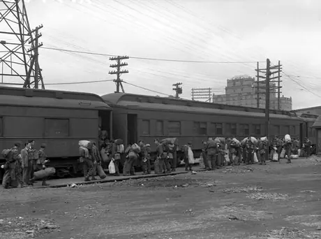 Troops returning from overseas board one of the many passenger cars in Halifax freight yard