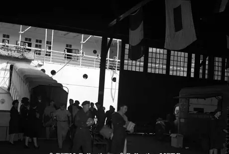 Troops enter Pier 21 after disembarking the C.N.S.S. Lady Nelson