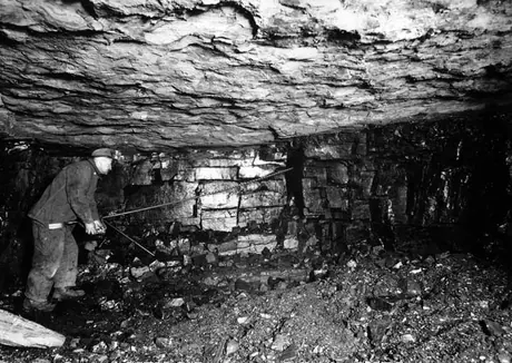 Drilling a hole to bring down coal which has been undercut by a Sullivan machine